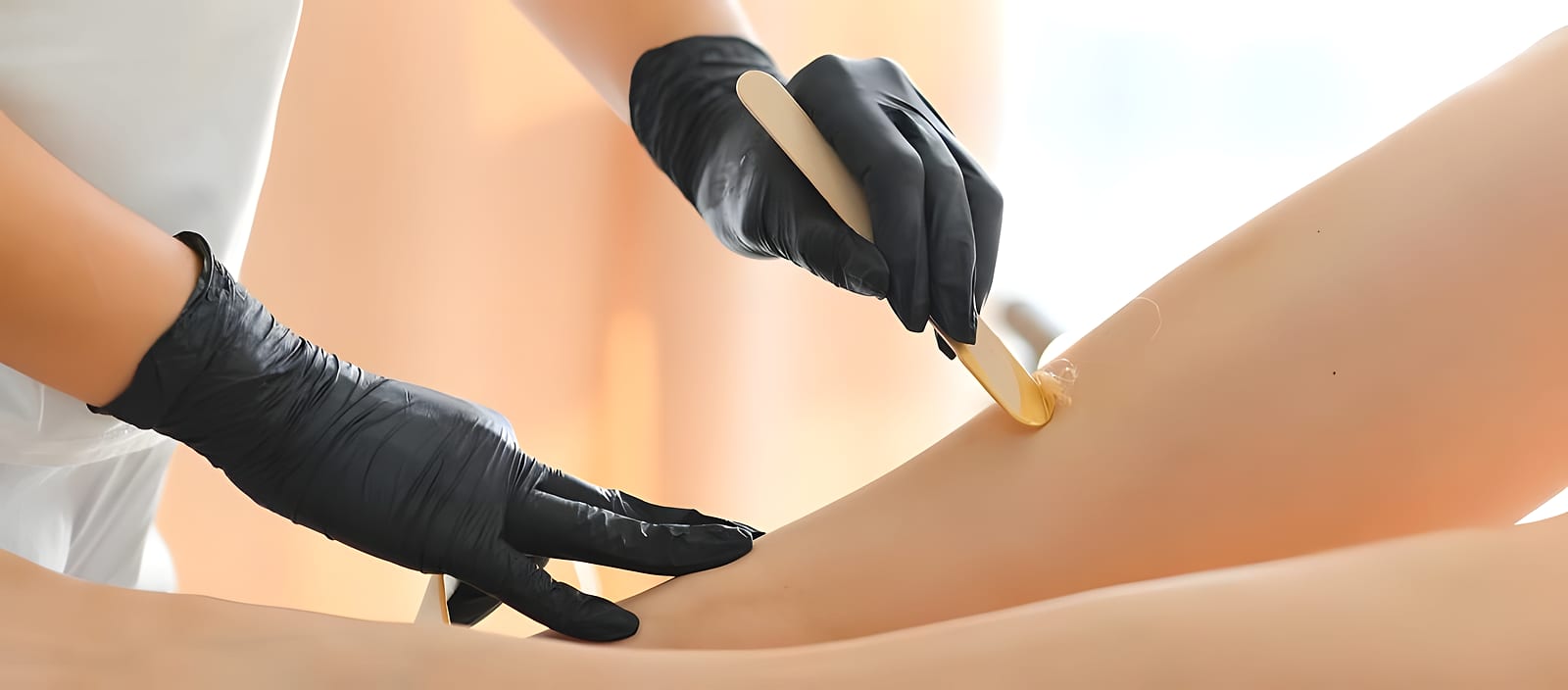 A technician applying wax during a waxing service